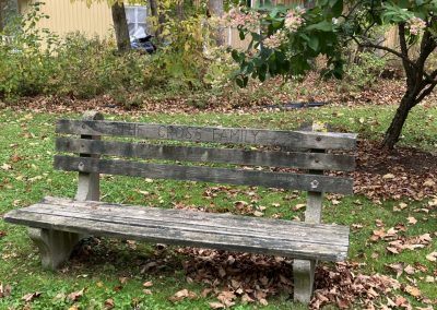 2023-11-09 The Cross Family Bench, located in Bayside, ME’s Scribner Park and submitted by Beverly Crofoot on behalf of the Bayside Historical Preservation Society. Harriette (Happy) Hilty provided the following history in October 2023: “The Ervin Cross family, living in Bangor at the time, came to Bayside 111 years ago. It’s possible that Loren Cross, father of Ervin and living in Morrill, may have visited Bayside before that. My mother, Harriette Cross Henninger, remembers her father, Ervin, renting Sunnyside cottage, Clinton Street, in 1912. Harriette’s mother, Ellen Ferguson Cross, bought the cottage, Forest Home, 23 Broadway, in 1921, with her earnings as a teacher. The cottage was eventually owned by Harriette Henninger Hilty and Kenneth Nunn. In 2012, Harriette (Happy) purchased Kenneth Nunn’s half of the cottage. The cottage will eventually be left to James E. Hilty, son of Harriette, and Katherine M. Hatcher, granddaughter. Loren and Annabelle Cross bought Columbia cottage that was located on Broadway about 1921. The cottage was on the now vacant lot between the Rand Camp and Stetser’s Marivista. After Loren and Annabelle died, Columbia was sold and moved. The front porch was installed on a cottage in Auditorium Park, and the remainder was moved to George Street and converted to a garage and storage space. The Cross Bench was placed in Scribner Park, its current location, so family members would have a place to wait for mail delivery to boxes located near where the library now is located.” Please consider joining the BHPS at https://www.baysidehps.org/index.php/donations/648/. #tbt #benches #memorialbenches #scribnerpark #baysidelibrary #cottagelife #oldbayside @baysidehps #bhps #baysidemaine