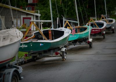 2023-12-11 Line Up, photographed in August at the Northport Yacht Club in Bayside, ME by Steve Nelson and showing the sailing school vessels neatly lined up, on their way to storage for the season. Looking for a Bayside-oriented gift? Steve sells a 2024 calendar using his photos at https://www.baysidephotos.com/product/2024-wall-calendar/. @nyc_bayside @snlsn #endoftheseason #pullingboats #sailboats #sailingschool #baysidemaine