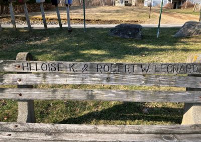 2023-12-14 The Leonard Bench, located at the top of the lower portion of Bayside, ME’s Bayview Park and submitted by Beverly Crofoot on behalf of the Bayside Historical Preservation Society. This bench was installed in Memory of Heloise Kennedy (1898-1978) and Robert Winslow Leonard (1928-1987). The following background was written by Don Webster, whose family home is located at the top of upper Bayview Park and can be seen in the center of this photo, over the bench. This bench was given by Don's mother, Adeline Rogers Webster (1908-1996). Peter Freeman and Fred Lincoln also shared the story of Bob Leonard buzzing Bayside. “Heloise was a dear friend of my mom. She lived in the house now owned by the Handwergers. Her son Robert was a pilot, I believe with the Navy. Occasionally, he would buzz Bayside on the way, I guess to some military airport. I was very young at this time, but I remember the pride Heloise, Mrs. Leonard to me, had when this happened. It was also the talk in Bayside for a week afterwards. I remember when we were hit with a hurricane back in the mid-fifties (Carol, August 1954) and walking down past Parker’s Store with my mom and Mrs. Leonard. The wind was blowing like hell, and she turns to mom and says it’s a bit breezy today. The largest cabin cruiser in the anchorage at that time was the Clement’s Folly, which had just washed up on the rocks just south of the wharf. During those years, I was just getting interested in cars. Mrs. Leonard had a ‘57 Chevrolet blue and white. For young car buffs like me, this was and still is considered a classic model year. Her car had roll up windows, not power windows, which was an anomaly with a car that otherwise was fully loaded. I asked her why one day, and she said ‘If I have an accident and go into the water, I want to be able to roll the windows down to escape; with power windows they might not work when the electric system gets wet.’” Please consider joining the BHPS at https://www.baysidehps.org/index.php/donations/648/. #tbt #benches #memorialbenches #historylesson #bayviewpark #cottagelife #oldbayside @baysidehps #bhps #baysidemaine