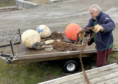2025-04-28 Good Mooring Gordon, photographed in Bayside, ME by David Leaming. “As the sailing season approaches, Northport Yacht Club Fleet Captain Gordon Fuller drags heavy mooring chain off a trailer onto a float at Bayside in Northport on April 22, 2025. Fuller has been servicing the 14 sailing school moorings and replacing shackles and pendants as needed while still recovering since last fall from a broken leg. Offers of help are always welcome.” Speaking of which, please join Gordon for one or more of the Northport Yacht Club Work Parties occurring on May 31 and June 7, 14, and 21 to help prepare the fleet for the summer. @nyc_bayside #baysidetreasure #goodmooring #moorings #mooringchain #preparingfortheseason #tangledmess #plentyofworktodo #communityservice #fleetcaptain #sailingschool #sailing #rugglespark #penobscotbay #baysidemaine