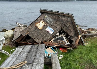 2025-05-25 End of an Era, photographed in Temple Heights, Northport, ME by Chris Ferry. Josh Ferry writes, “The shed at Temple Heights point is officially being removed. It was constructed in 1958 by Lynn Hayward and his brother Alan with materials they found at the dump. It was partially leveled in one of last year’s storms. Lynn is the one removing it after 67 years. It will certainly change the landscape not having it there.” #endofanera #deadshed #stormdamage #templeheights #penobscotbay #baysidemaine
