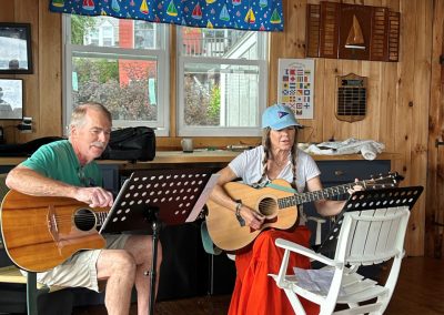2025-07-28 Celebrities Among Us, photographed at the Northport Yacht Club in Bayside, ME by Jim Ross. “There was a surprise appearance of Carl Oberg and Suzanne Rico at the ‘Donuts on the Deck’ open house on Sunday, July 21, at the Yacht Club. We heard several old and familiar songs from the likes of John Denver, Joni Michell, Elton John and Janis Joplin!” Suzanne will be performing at Marshall Wharf in Belfast on Wednesday, July 30 at 6 PM (https://www.marshallwharfbrewing.com/events-one), and the next Donuts on the Deck event is scheduled for Sunday, August 10 from 9-11 AM. @nyc_bayside @suzannerico @obergcarl #music #celebrities #guitarduo #donuts #donutsonthedeck #baysidemaine