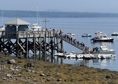 2025-08-05 Teamwork, photographed by Judy Scholhamer from her cottage in Bayside, ME last week. “Loved sitting on our Bay Street porch and watching the teamwork of unloading gear after the [Northport Junior Yacht Club’s Warren Island] overnight campout! It really does take a village!” @nyc_bayside #teamwork #camping #campout #sleepdeprived #cantwaittoshower #warrenisland #warrenislandstatepark #northportjunioryachtclub #baysidemaine