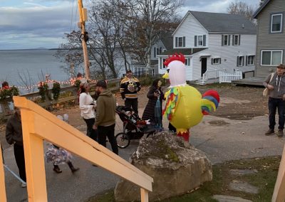 2025-11-03 Halloween Thank You, submitted by Celine Bewsher and showing trick-or-treaters at the bottom of Clinton Avenue in Bayside, ME. Celine shares the following thank you message: “What a Halloween Bayside created for the kiddos! It was wonderful to see so many students and parents from Drinkwater this year—the costumes were so creative! Someone said to me, ‘You must love Halloween.’ Full disclosure: I’m actually not a Halloween person. For me, it’s all about taking this opportunity to make it fun for the kids and bringing our community—spanning generations—together to make it happen. A huge thank you to everyone involved. The list would be endless, but I do want to give a special shout-out to Jackie Facey—nothing stops this woman from making the Yacht Club such a magical place for the kids every Halloween! As the saying goes, ‘It takes a village.’ But truly, it takes a village like ours!” #ittakesavillage #halloween @nyc_bayside #community #communityservice #penobscotbay #baysidemaine
