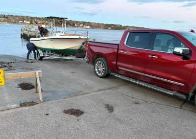 2025-12-01 Boating Season Officially Over, photographed at the Belfast boat ramp by Bill Haverty. “Alma (Bewsher) finally decided to call it a season.” And it looks like she had some neighborly help. #boathauling #seasonsend #belfastboatramp #penobscotbay #belfastmaine #baysidemaine