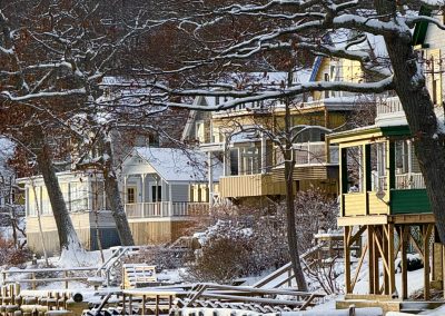 2025-12-03 First Snow, photographed in Bayside, ME by Leanne Budolfson as the morning sunlight reflected off Bay Street’s cottages. #firstsnow #snowfall #beachsnow #sunrise #penobscotbay #baysidemaine