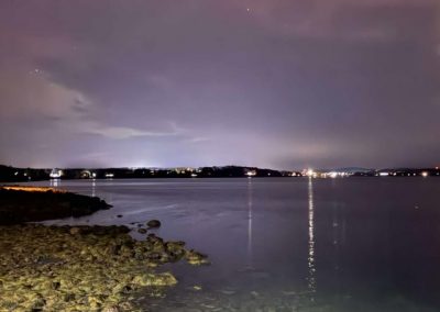 2025-12-09 Green Beach, Pink Sky, photographed by Katie Allen on the beach in Bayside, ME in mid-November, as the Northern Lights lit up the sky. #northernlights #penobscotbay #nightsky #belfastmaine #baysidemaine